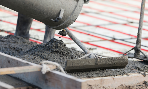 Concrete being poured and spread